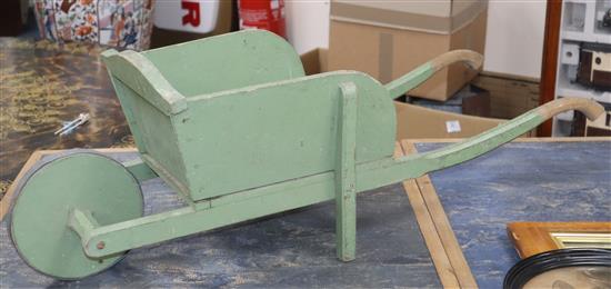 A childs painted wheelbarrow length 92cm